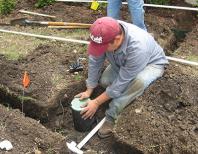 Installing a new valve and cover during a routine sprinkler repair in Miami Beach